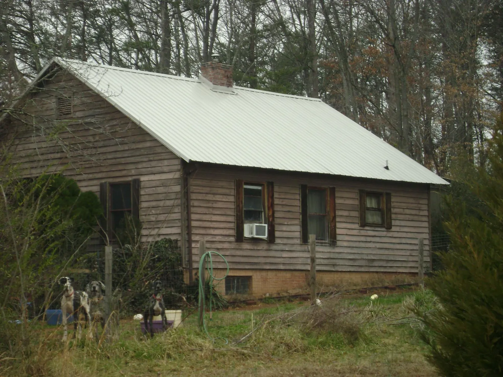 White metal roof on an old wood sided farmhouse, from a Metal Roof Installation job in Skippers